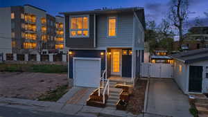 Contemporary house featuring a gate and a garage