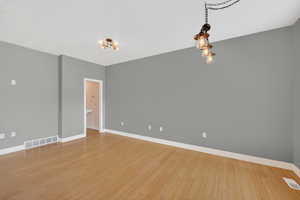 Open concept family room / dining room with baseboards and light wood-style floors