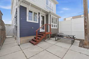 Rear view of house with a gate, a patio area, and entry steps