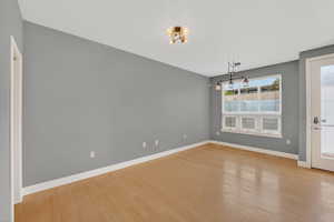 Unfurnished dining area with light wood finished floors and suspended lighting