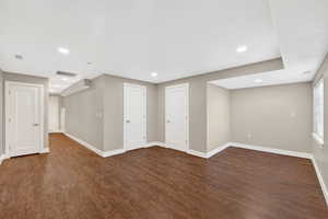 Basement featuring dark wood-style floors and recessed lighting