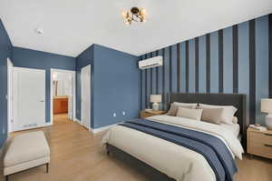 Bedroom featuring light wood finished floors, a closet, and wallpapered walls