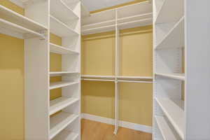 Spacious walk in closet custom shelving