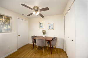 Dining room with light wood-style flooring and a ceiling fan