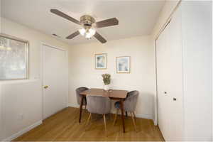 Dining space with light wood finished floors and ceiling fan