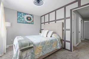 Bedroom with carpet flooring and baseboards