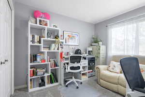 Office featuring light colored carpet and baseboards