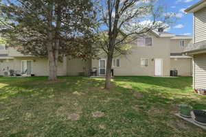 View of green lawn with a patio area