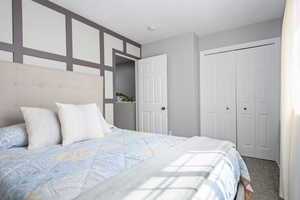 Carpeted bedroom featuring a closet