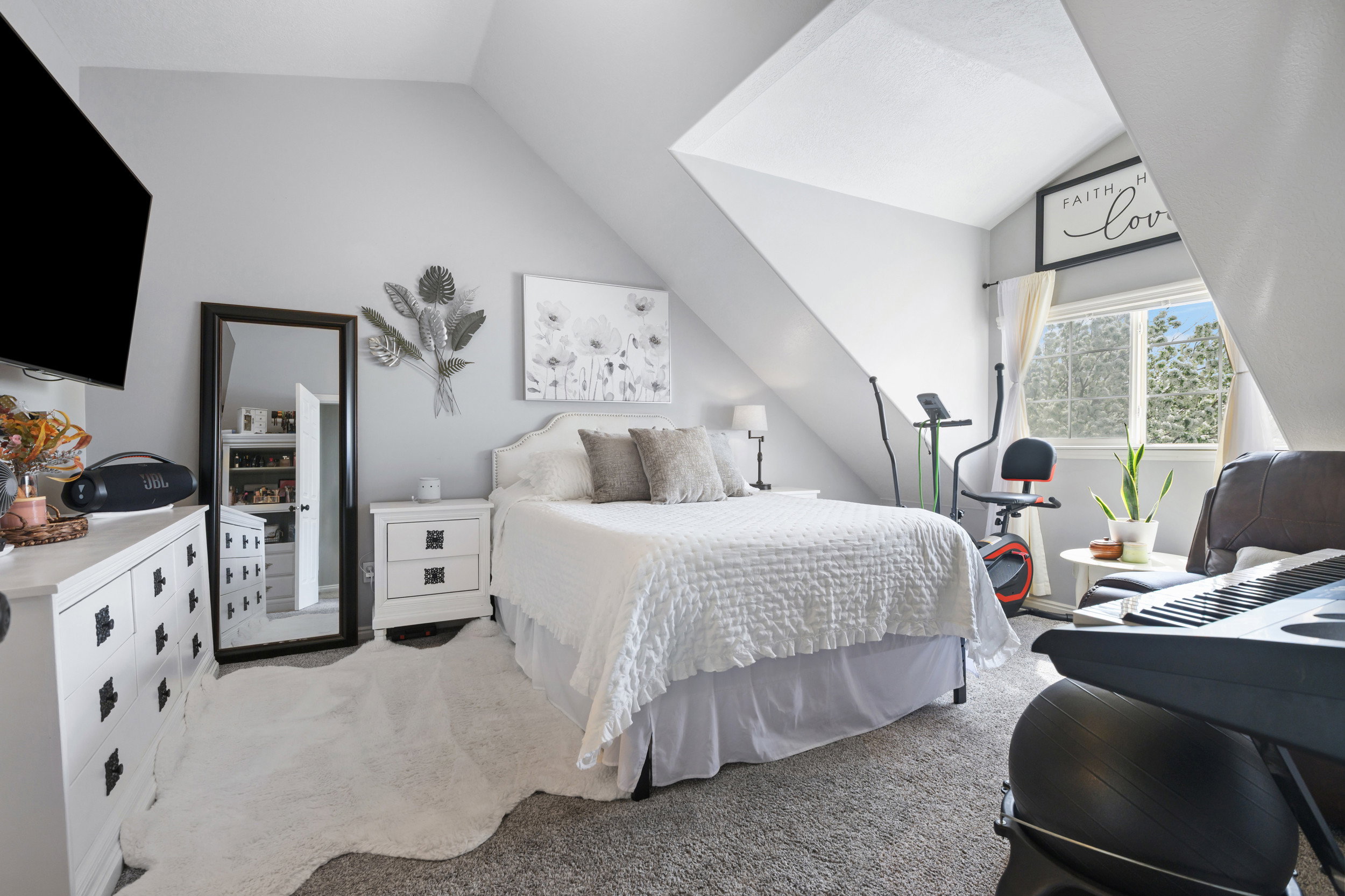 Bedroom featuring light colored carpet and lofted ceiling