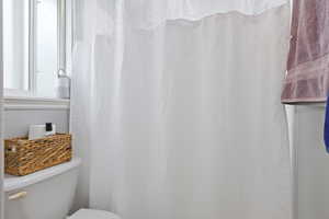 Bathroom featuring a shower with curtain