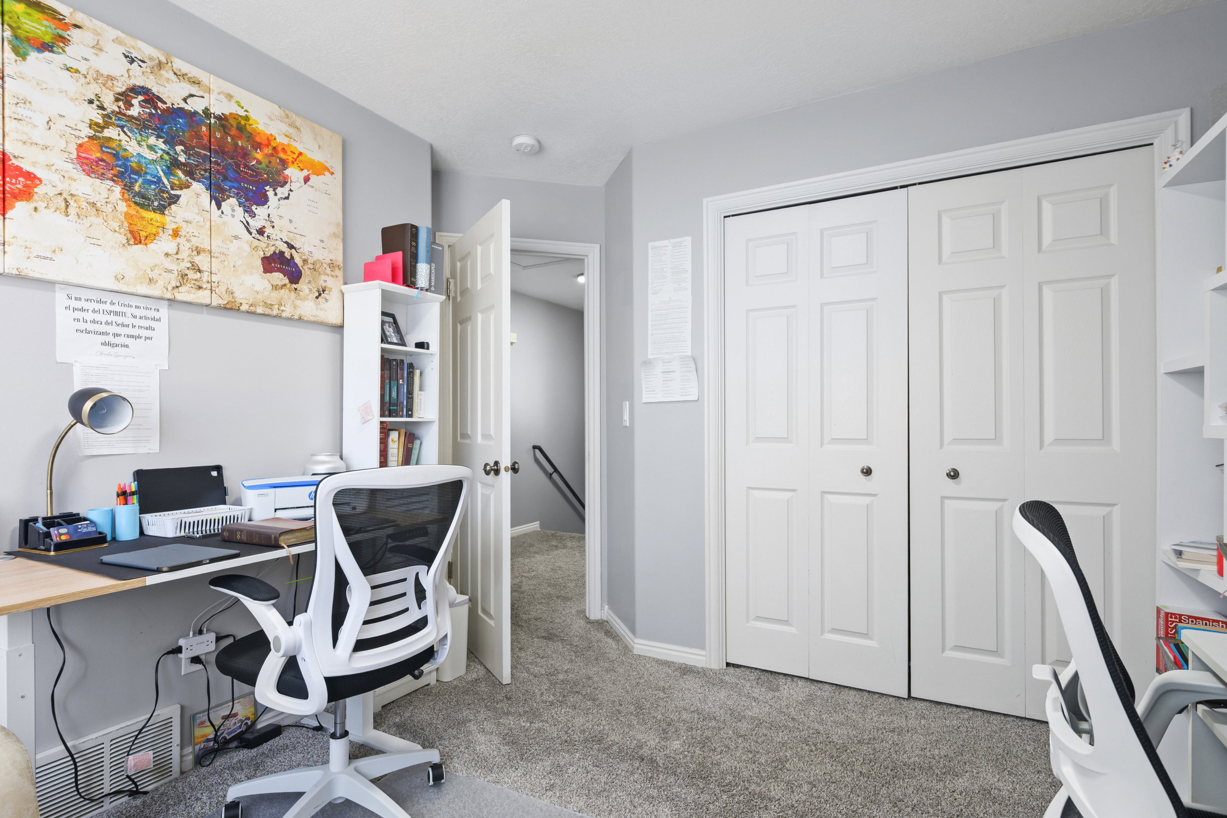 Home office featuring light colored carpet and baseboards