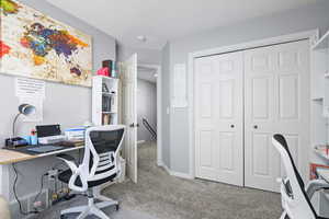 Home office featuring light colored carpet and baseboards
