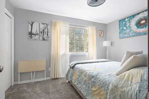 Bedroom with carpet flooring and baseboards