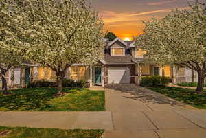 View of front of house with driveway, a front lawn, a garage, and roof with shingles