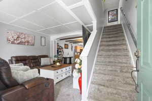 Staircase with arched walkways and carpet