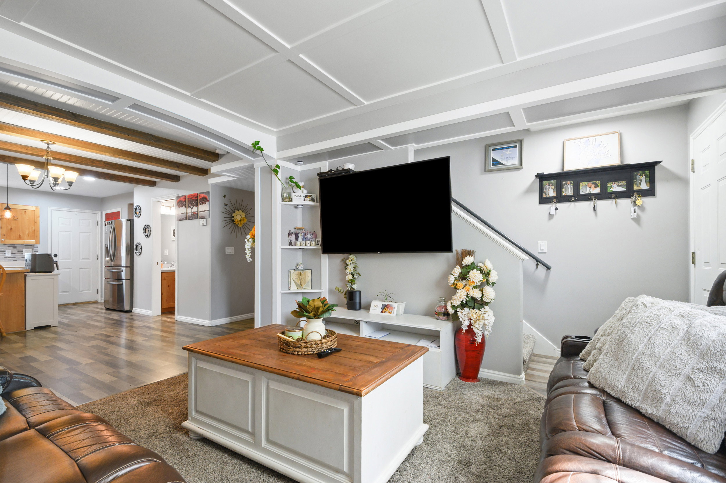 Living room featuring baseboards and suspended lighting