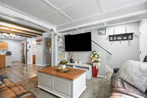 Living room featuring baseboards and suspended lighting