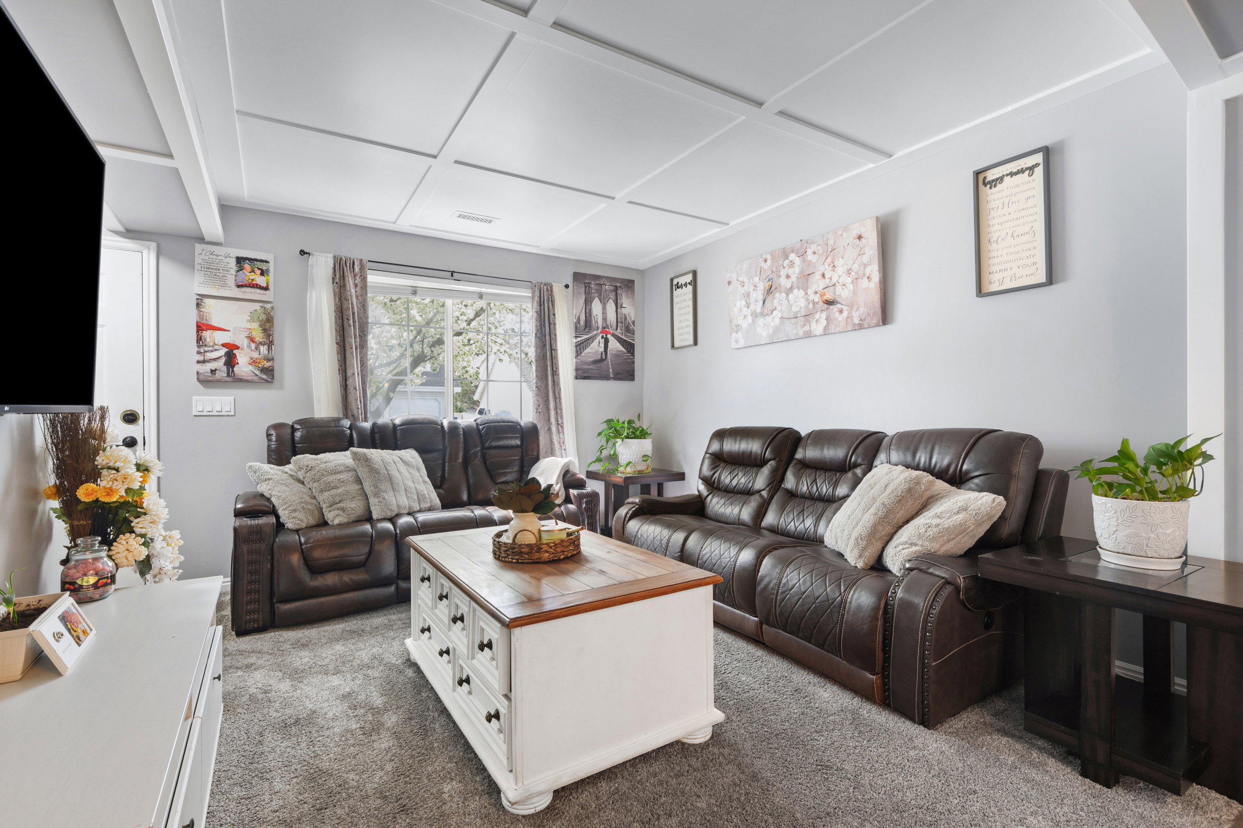 Living room featuring carpet and coffered ceiling
