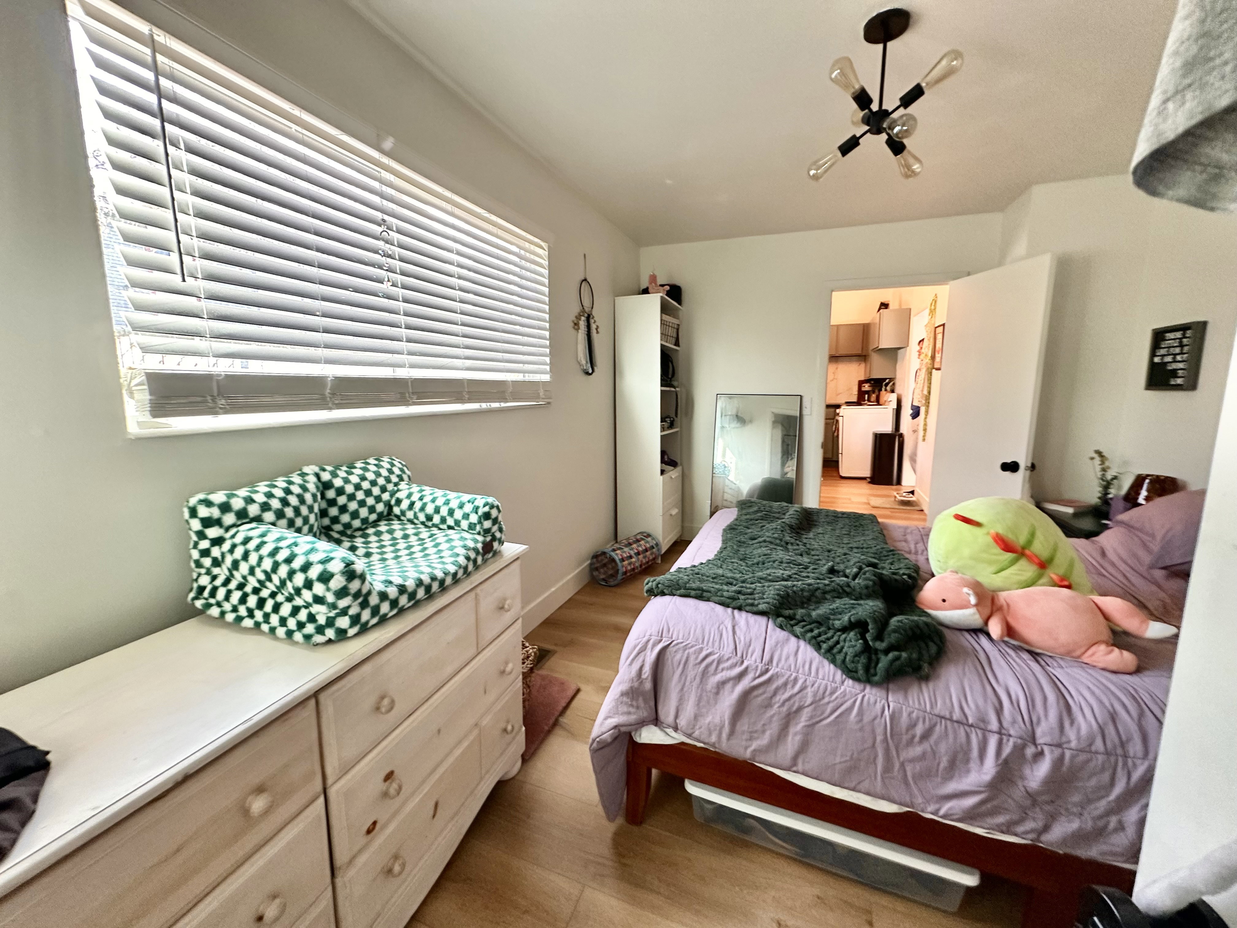 Bedroom with light wood finished floors and baseboards