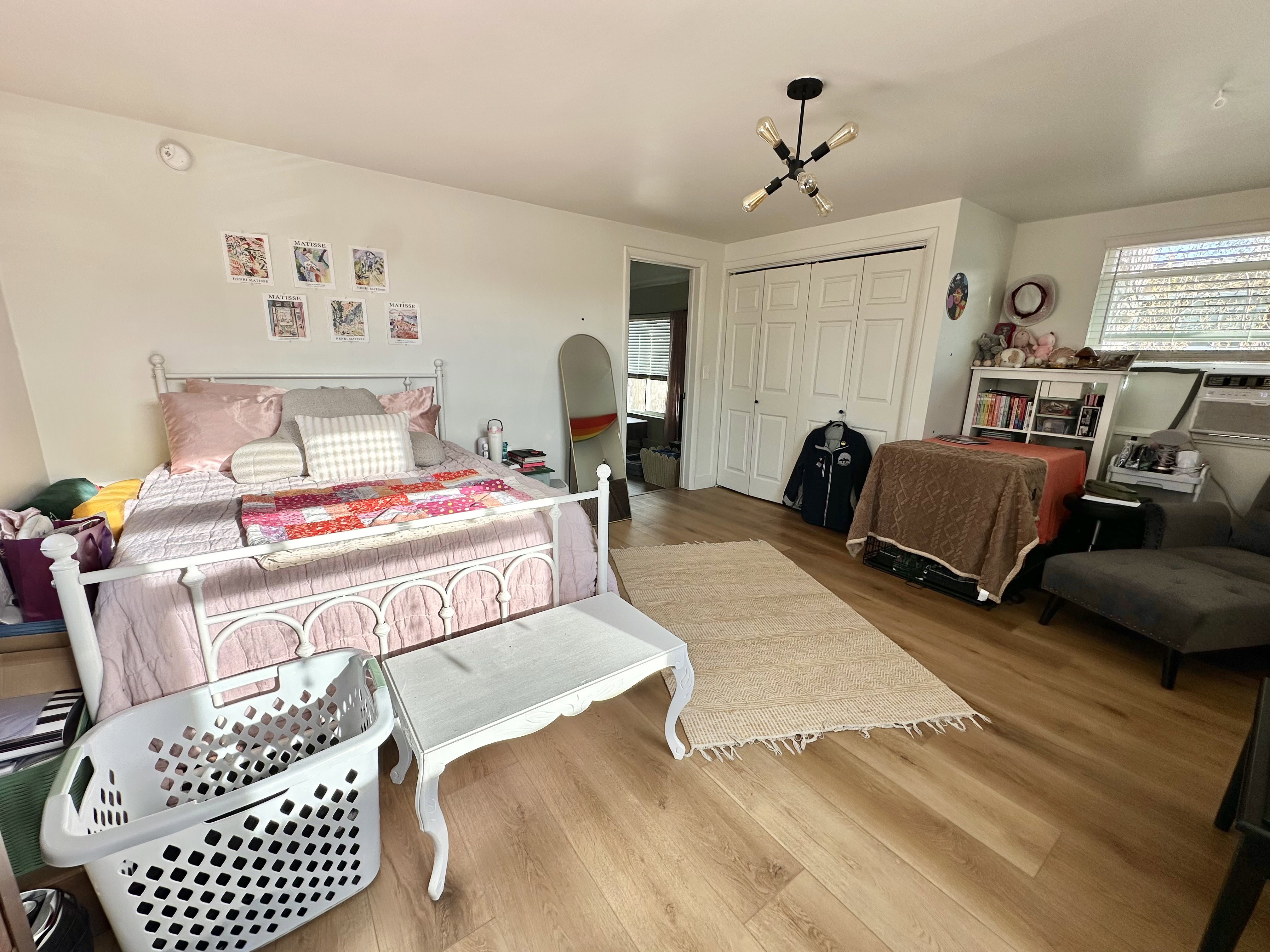 Bedroom featuring wood finished floors, multiple windows, and a closet
