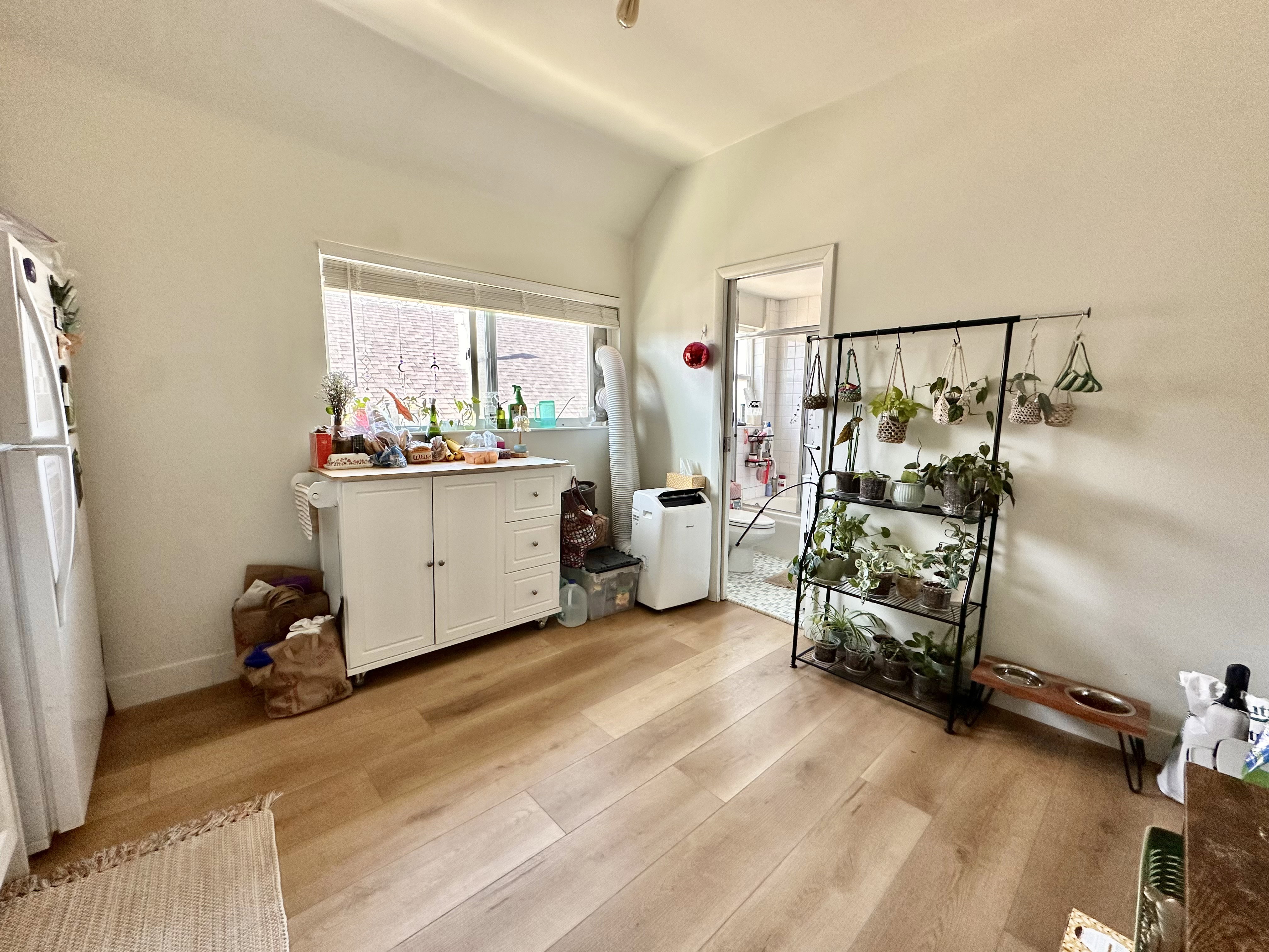 Dining area with light wood-style flooring and lofted ceiling