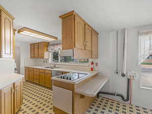 Big kitchen with a new cooktop, solid wood cabinets
