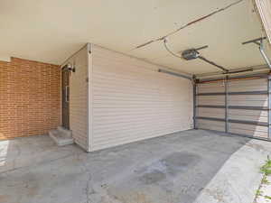 Carport with a garage door - install a partition wall on the east side for a fully-enclosed garage