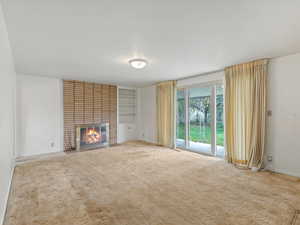 Living room - hardwood floors under the carpet! Big sliding door to the back patio
