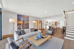 Living room featuring light wood-style flooring and recessed lighting