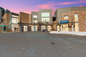 Property at dusk featuring view of commercial area