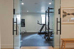 Workout area featuring baseboards and recessed lighting