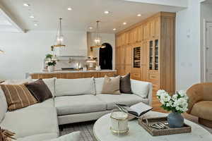 Living area with arched walkways and recessed lighting