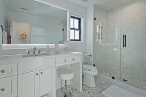 Bathroom featuring a stall shower and vanity