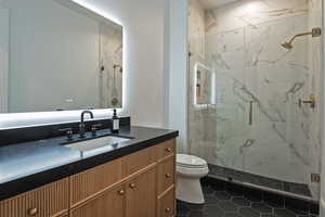 Full bathroom with vanity and a marble finish shower