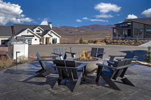 View of patio / terrace featuring an outdoor fire pit and a mountain view