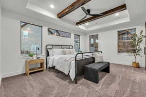 Carpeted bedroom with ceiling fan, recessed lighting, a tray ceiling, and beamed ceiling