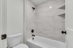 Bathroom with toilet and shower / bath combination