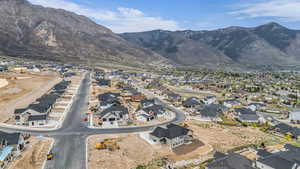 Aerial view of property's location featuring nearby suburban area and a mountain backdrop