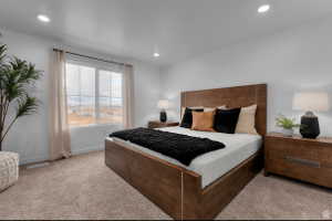 Bedroom with light colored carpet and recessed lighting