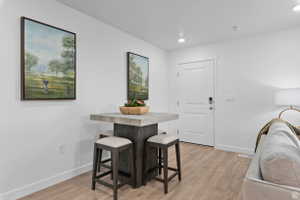 Dining room featuring light wood finished floors and recessed lighting