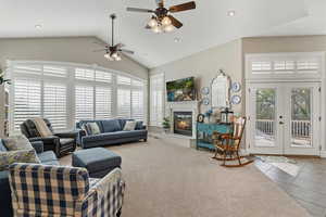 Living area featuring ceiling fan, french doors, vaulted ceiling, recessed lighting, and carpet flooring
