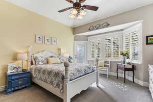Bedroom with carpet flooring, a ceiling fan, and access to outside