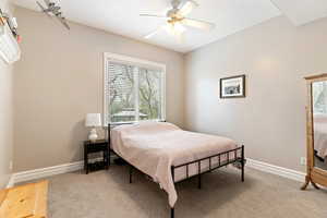 Bedroom featuring light colored carpet and ceiling fan