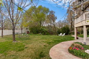 Fenced backyard featuring a patio area and a playground