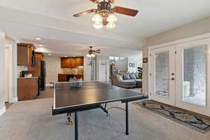 Recreation room with french doors, recessed lighting, light colored carpet, and ceiling fan