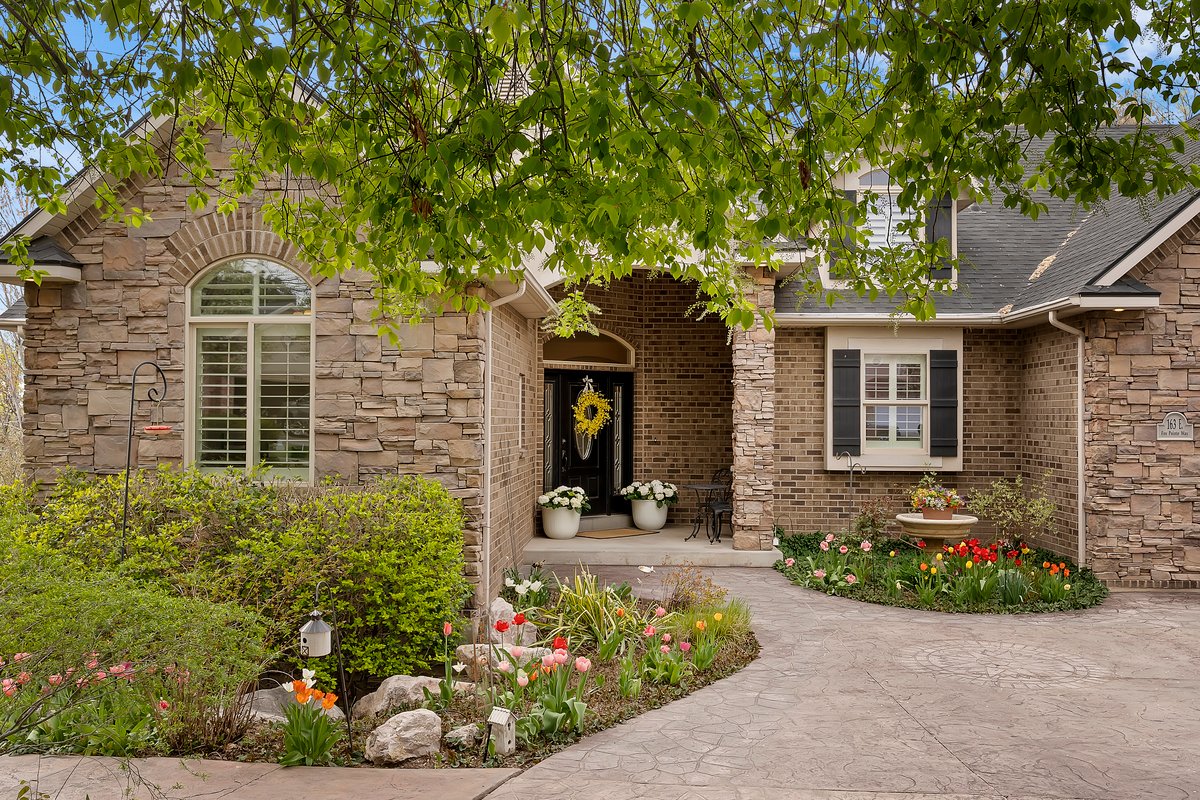 Property entrance with stone siding and roof with shingles