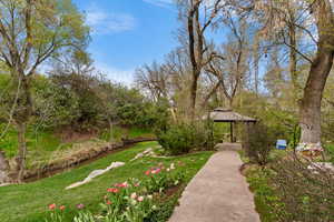 Surrounding community featuring a water view and a gazebo