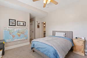 Bedroom with light colored carpet and ceiling fan
