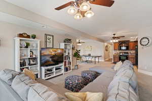 Living area featuring recessed lighting, light carpet, and ceiling fan